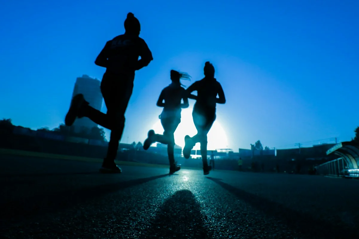 Endurance marathon athlete wearing wearable core body temperature sensor on chest strap during high-intensity training